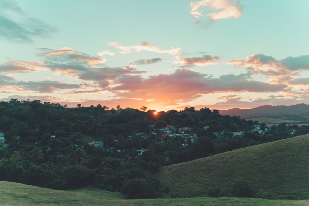 the sun is setting over a small town