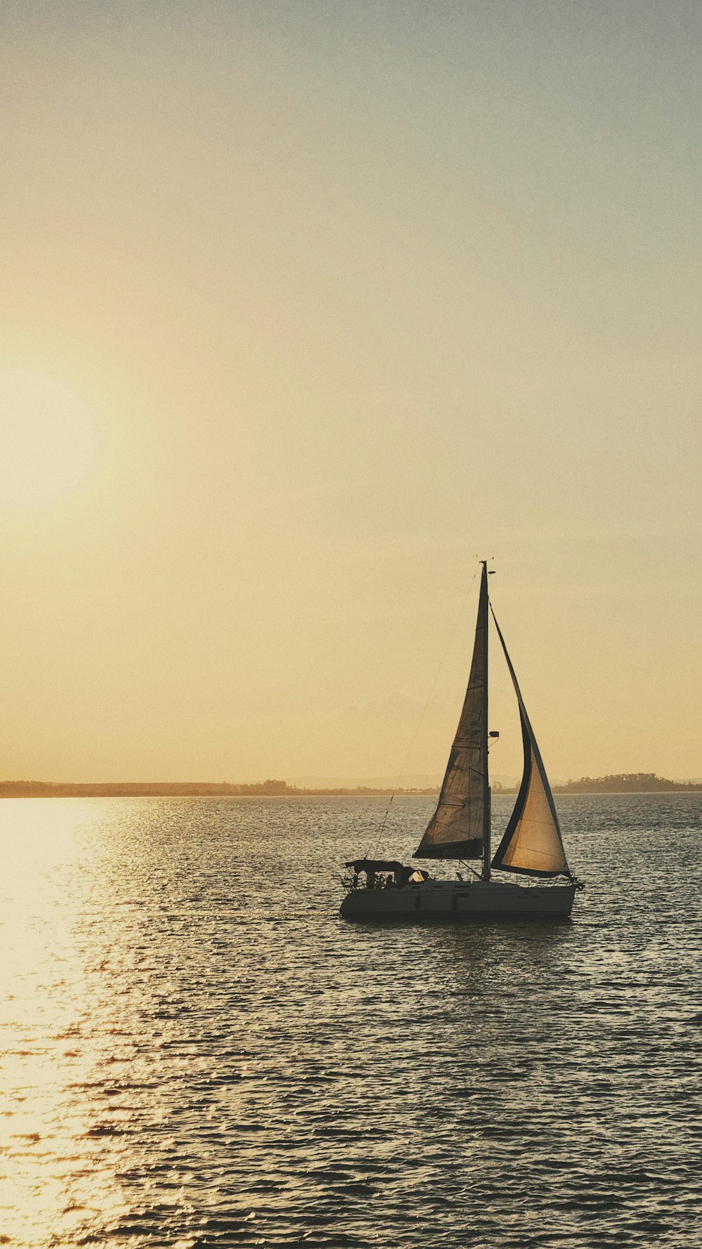 a sailboat sailing across a large body of water