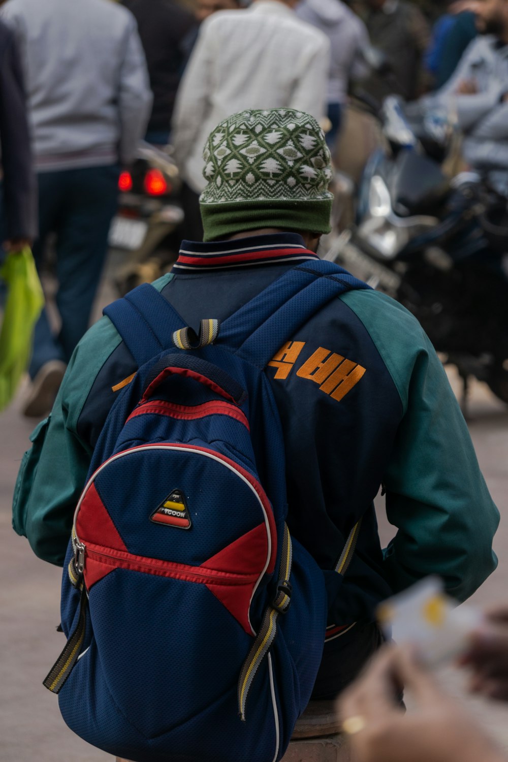 a man walking down a street with a backpack on his back