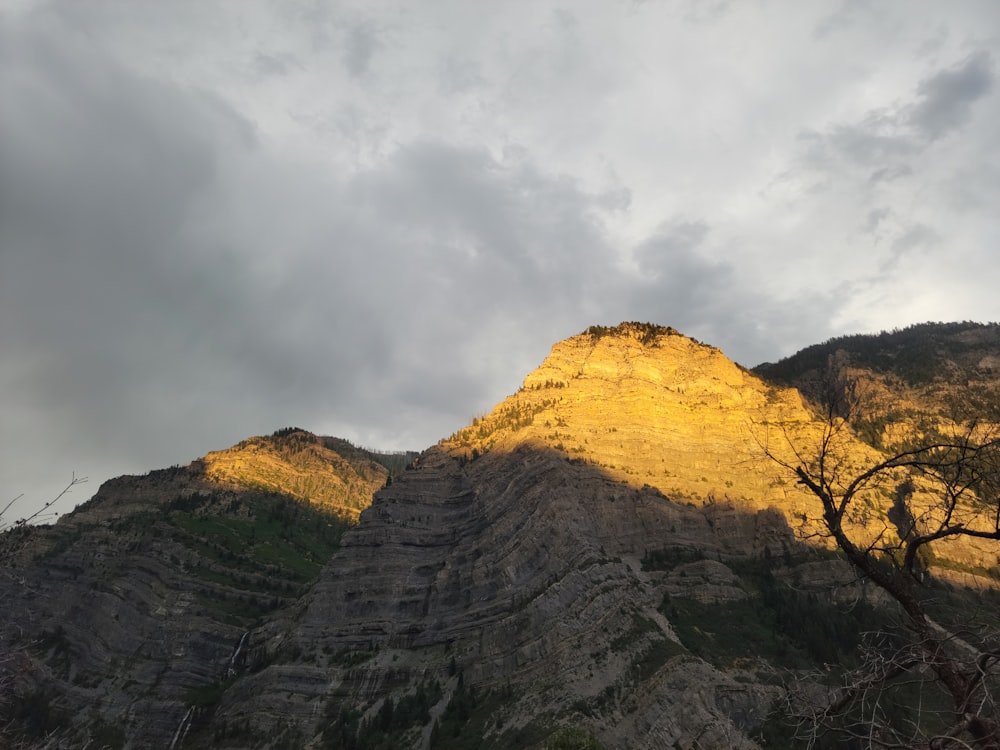 a very tall mountain with a sky in the background