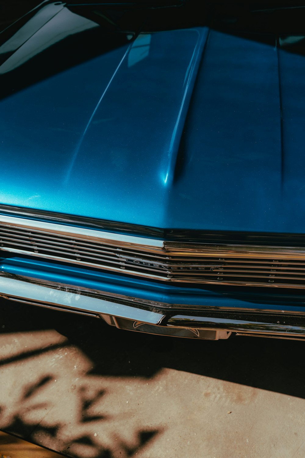 a close up of the front of a blue car