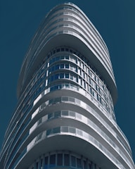 A sleek office tower in Dubai with a clear blue sky backdrop.