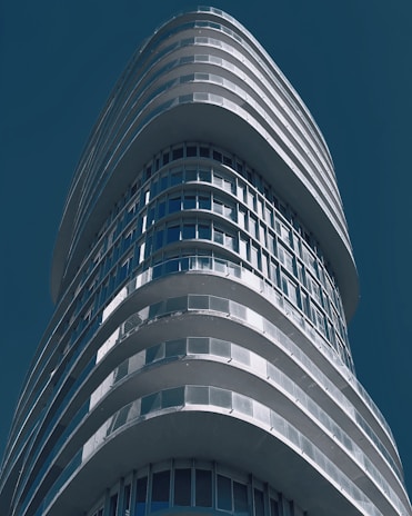 A sleek, modern skyscraper representing onebury's global headquarters under a clear blue sky.
