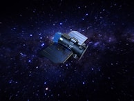 A spacecraft with solar panels navigates through a starry space backdrop, featuring arrays of purple and blue hues against a dark sky.