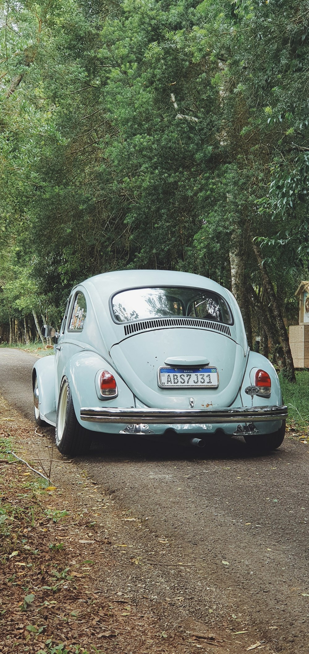 a blue car parked on the side of a road