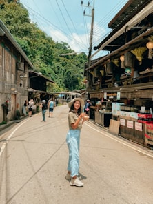 a woman standing in the middle of a street