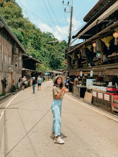 a woman standing in the middle of a street
