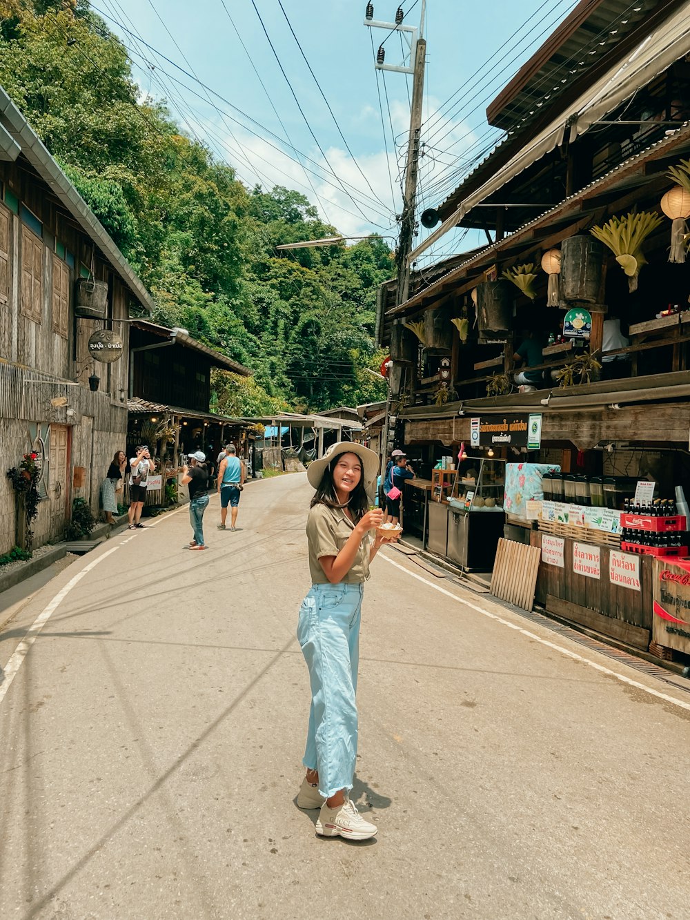 a woman standing in the middle of a street