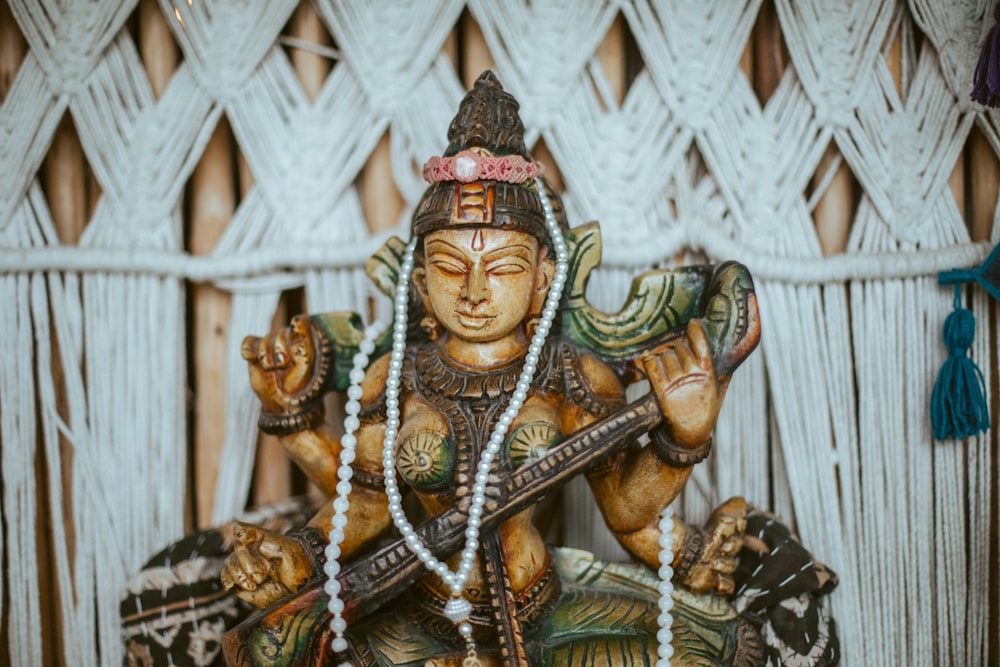 a statue of a hindu god holding a sword