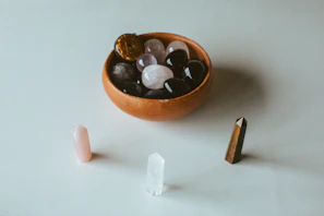 A collection of polished aquamarine stones arranged artfully on a light wooden tray