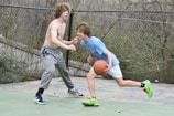 Young players dribbling intensely during a basketball drill on the outdoor turf.