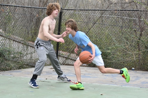 Young players practicing dribbling drills on an outdoor basketball court in Chennai