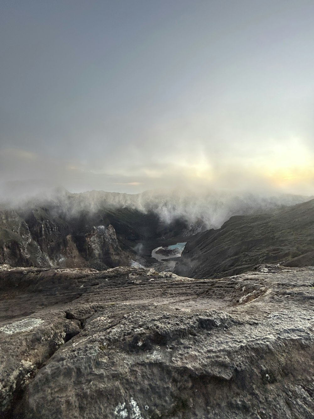 a view of a mountain range with a body of water in the distance