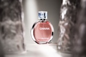 A close-up of a Luce fragrance bottle with soft lighting.