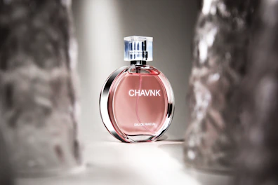 Delicate vanilla perfume bottle with soft light highlighting its smooth curves.