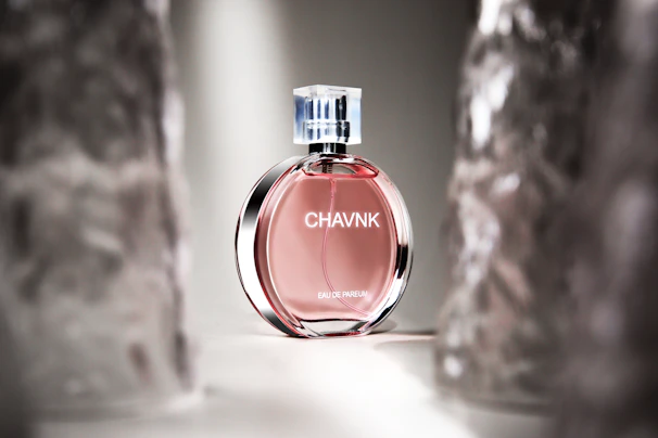 Close-up of an elegant perfume bottle with golden accents reflecting soft light.