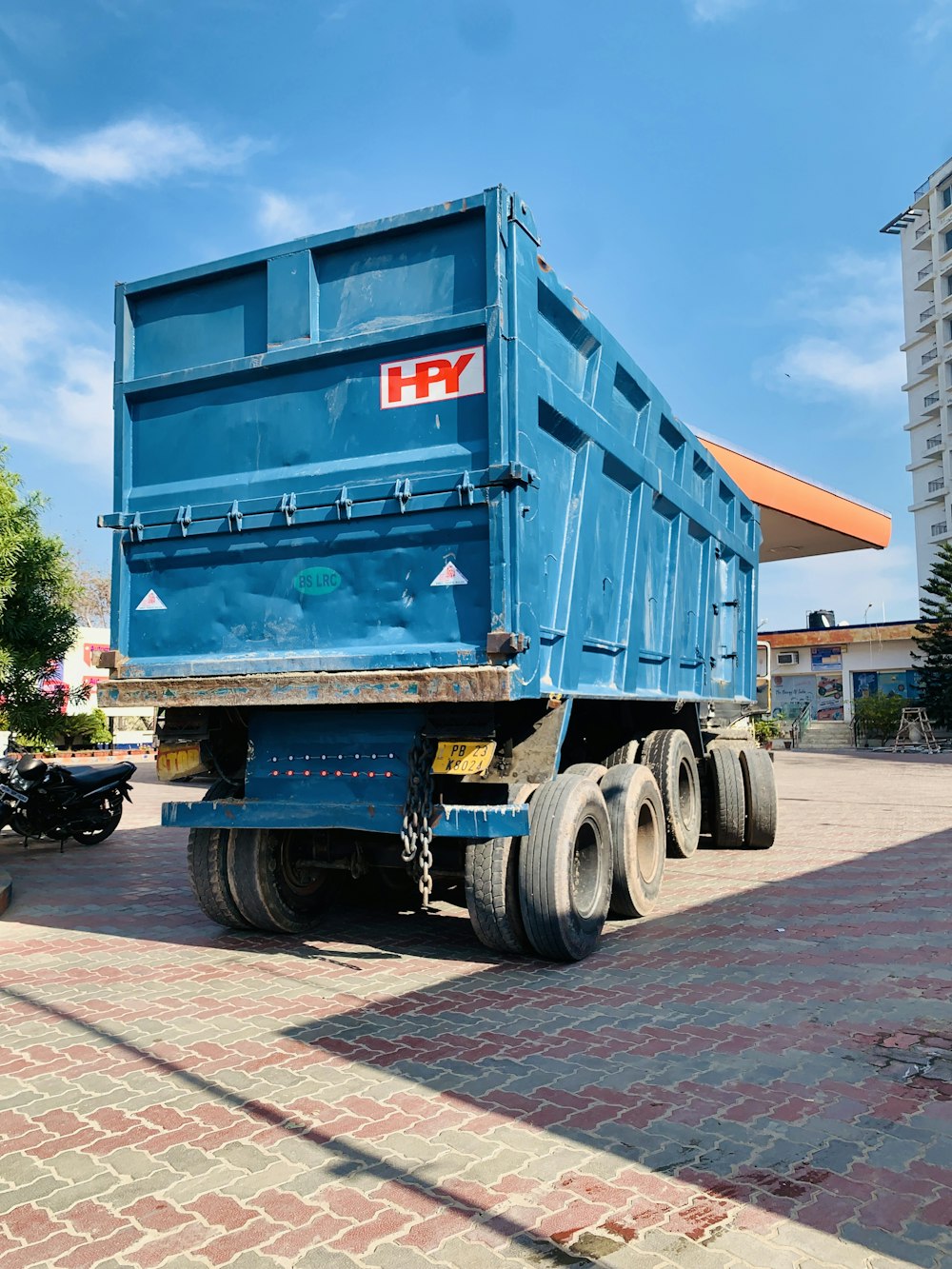 a blue dump truck parked in a parking lot