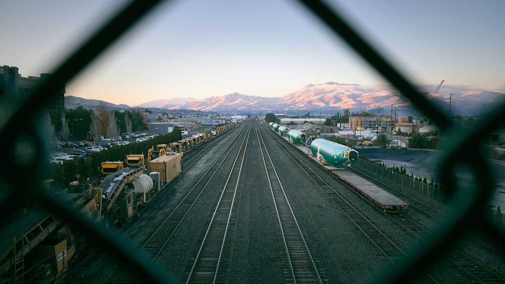 a view of a train yard through a fence