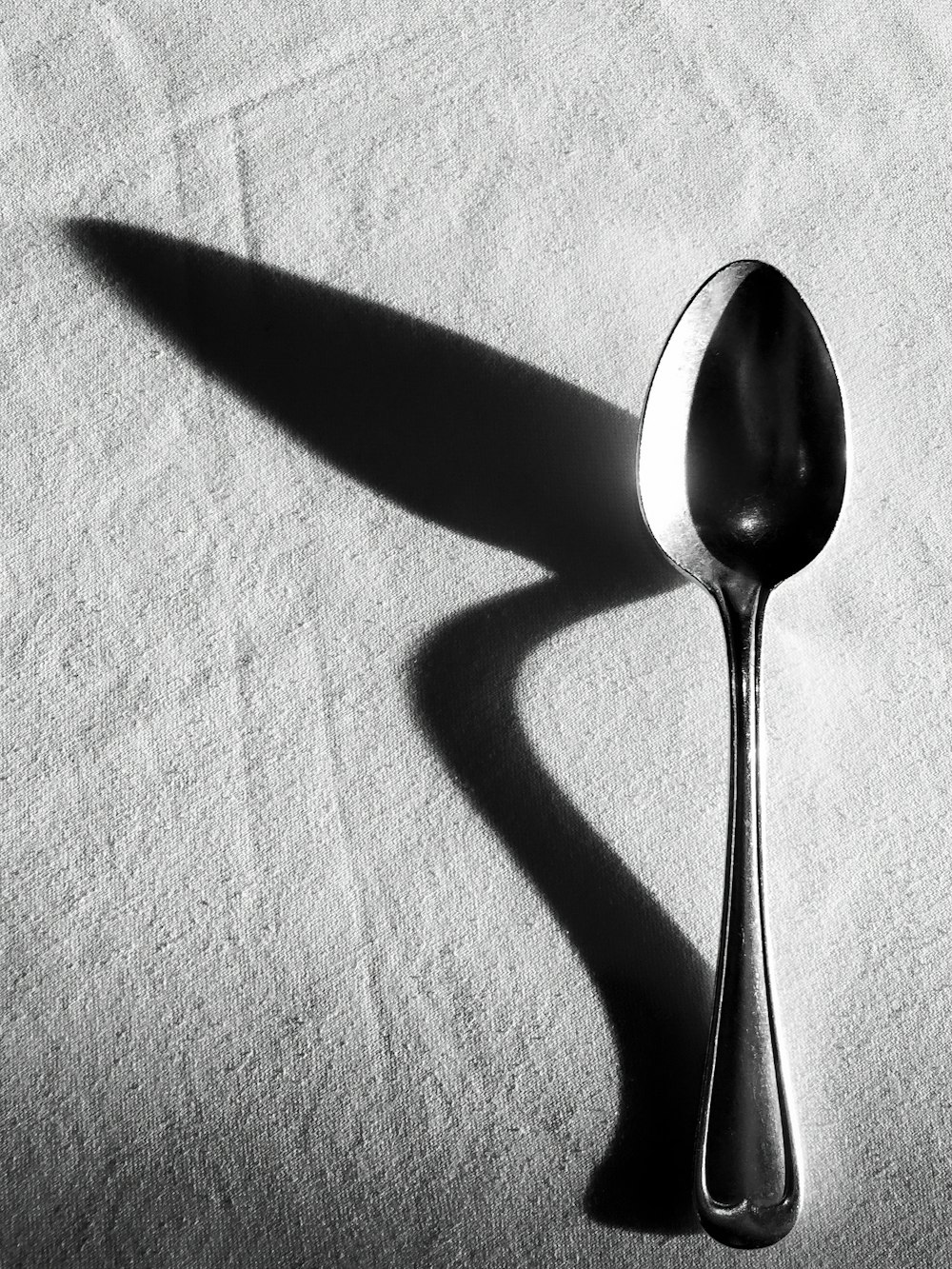 a spoon sitting on top of a white cloth