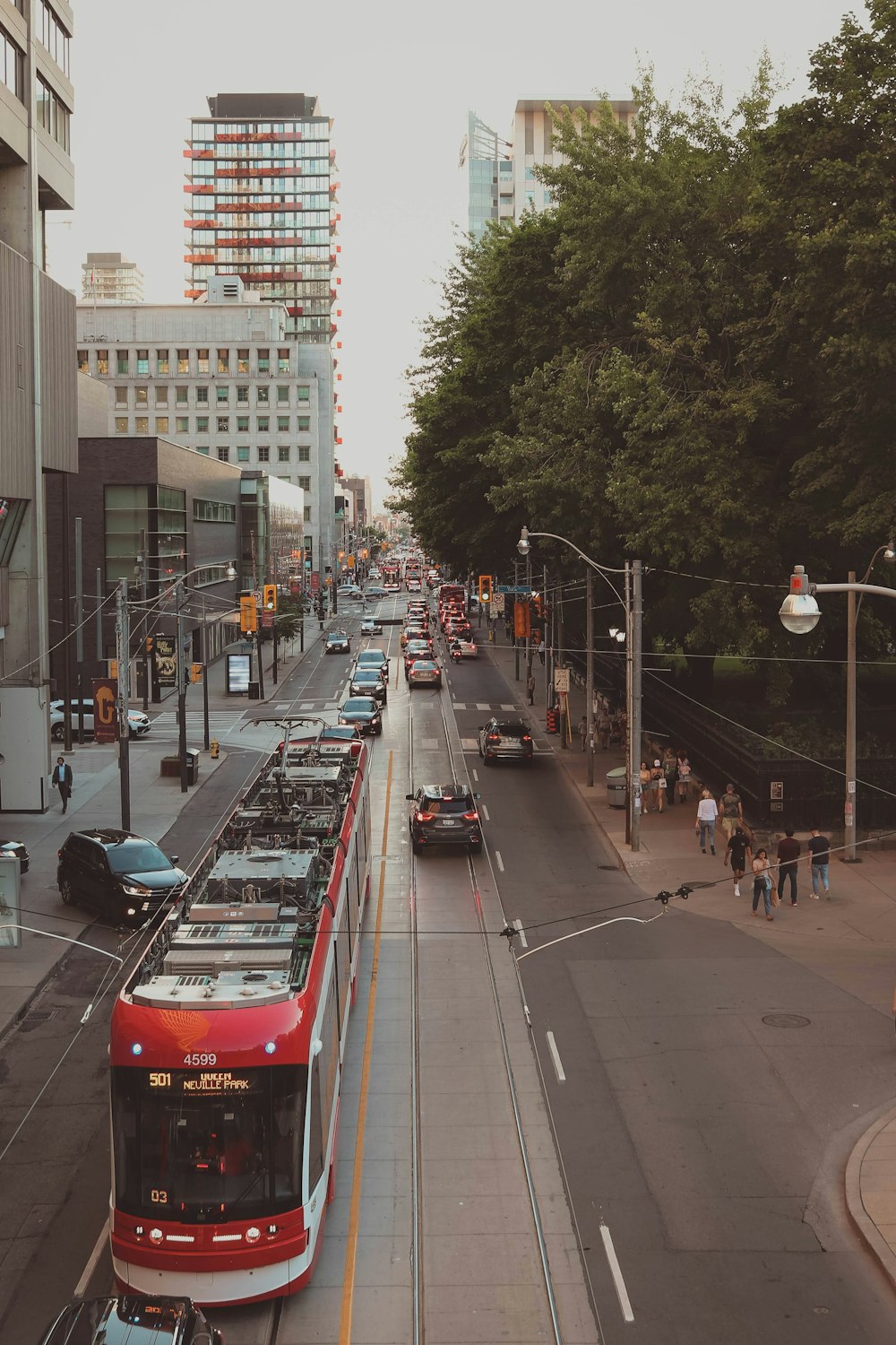 a city street filled with lots of traffic next to tall buildings