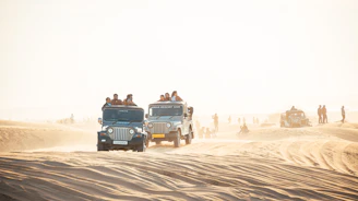 A group enjoying quad biking across the rocky Agafay Desert landscape.