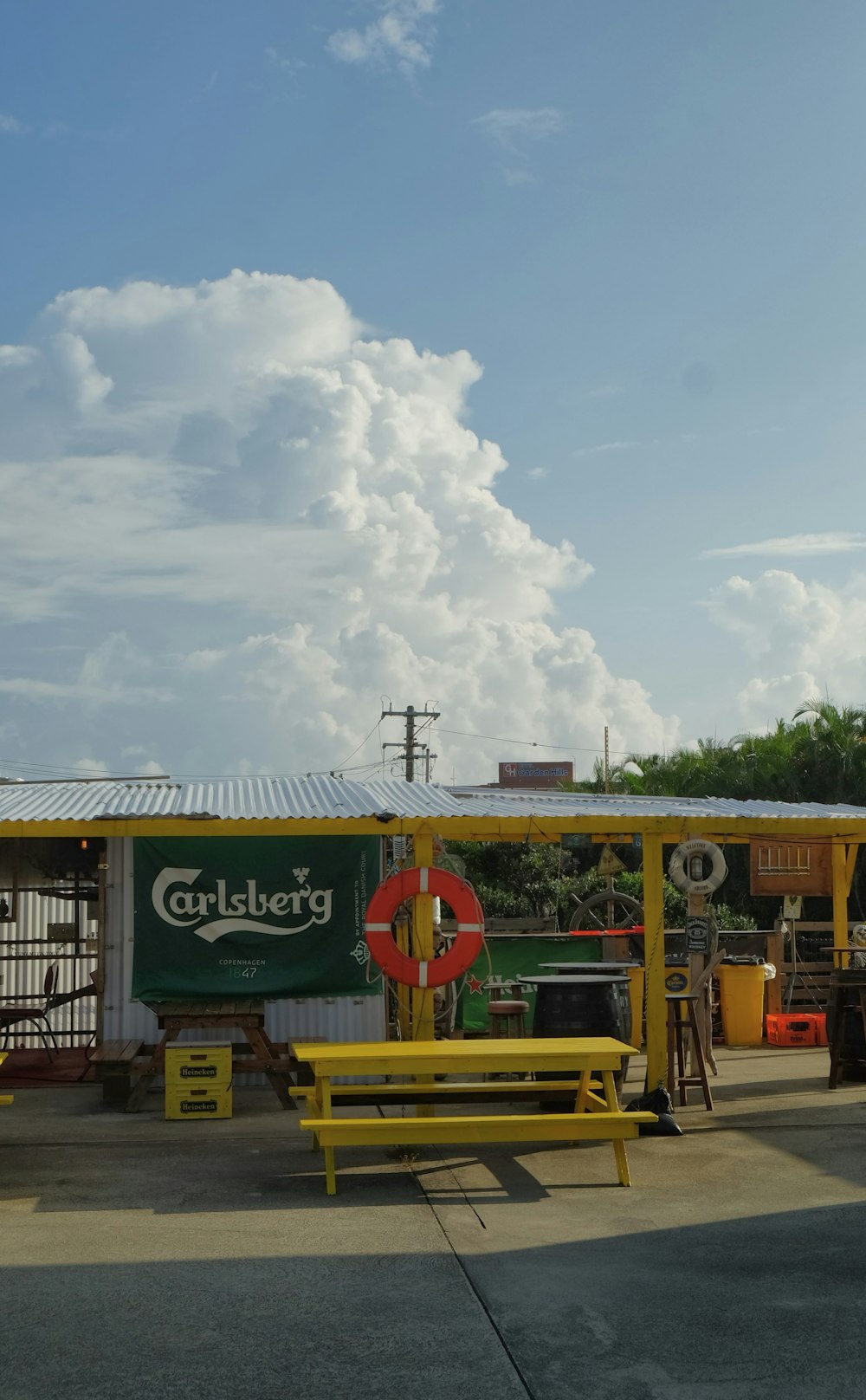 a yellow bench sitting in front of a building