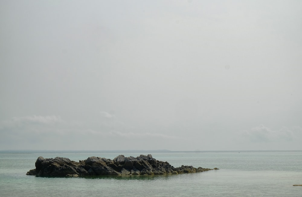 a large rock out in the middle of the ocean