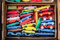 a box filled with lots of colorful toy cars