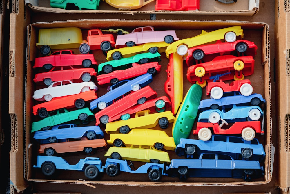 a box filled with lots of colorful toy cars