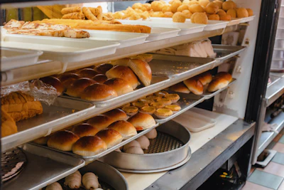 A bakery filled with different types of fresh bread on display