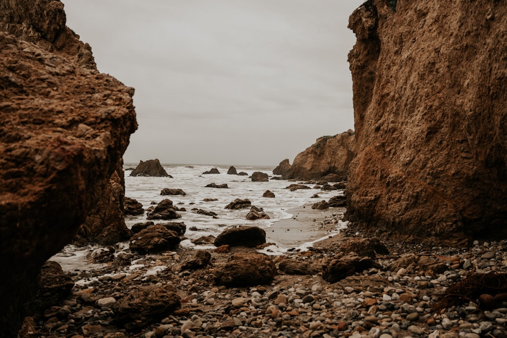 a view of the ocean from a rocky beach