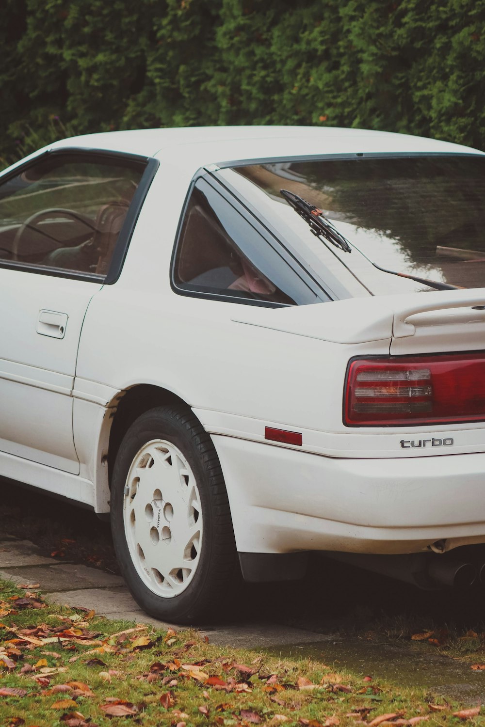 a white car parked on the side of the road