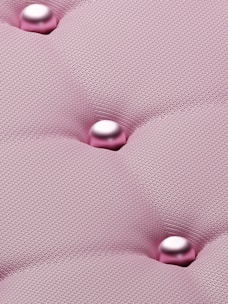 a close up of a pink upholstered material