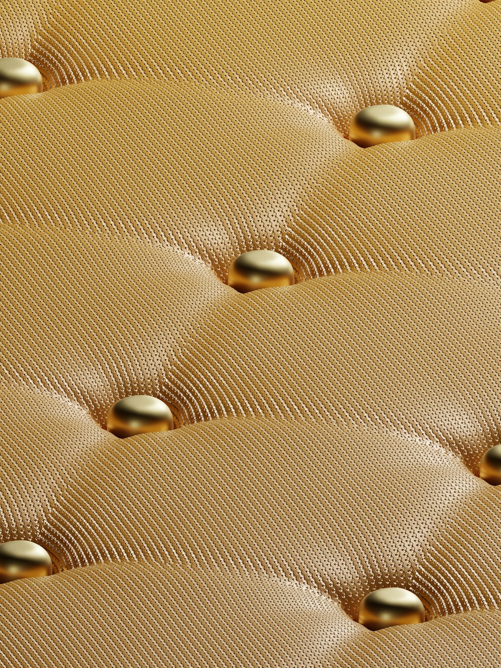 a close up view of a gold colored mattress