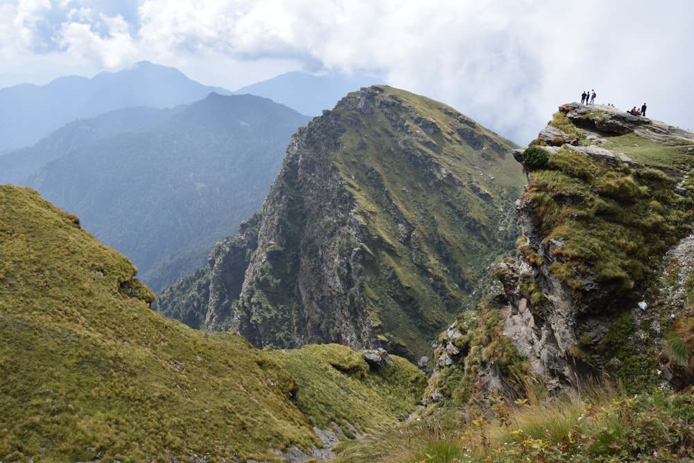 a group of people standing on top of a mountain