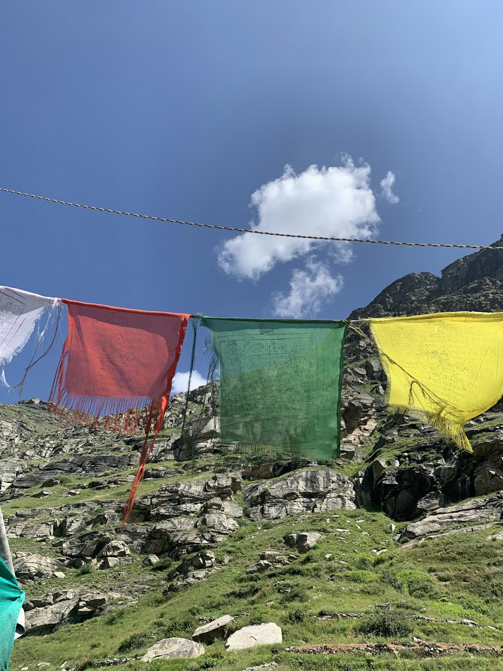 a line of colorful clothes hanging on a clothes line