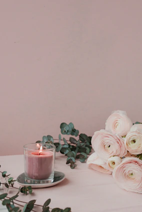 a candle and some flowers on a table