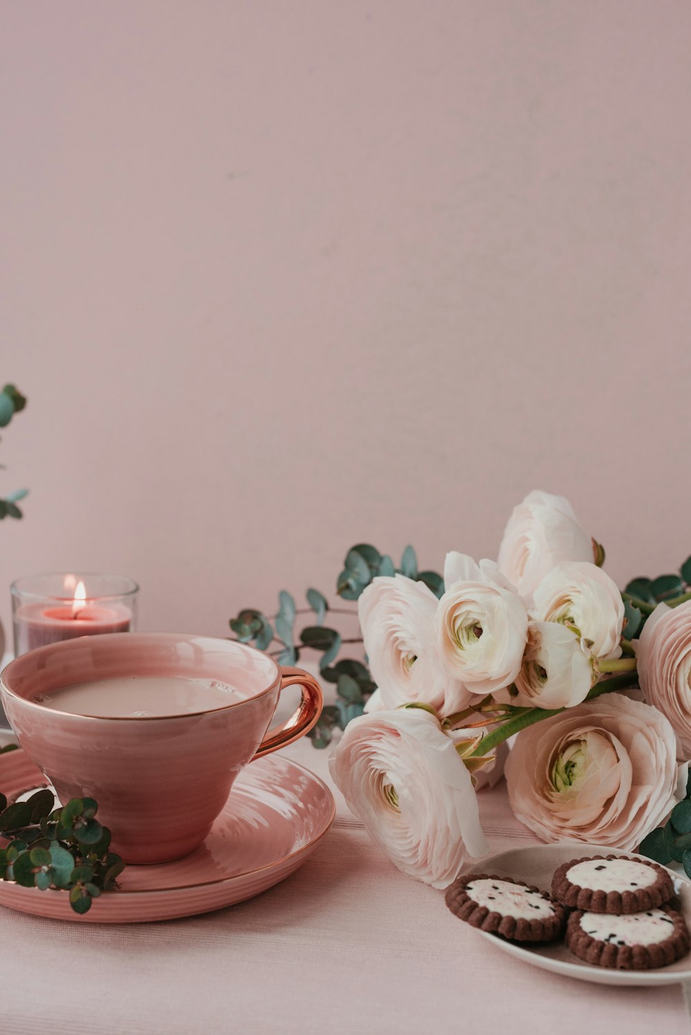 a cup of coffee and some cookies on a table