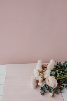 Softly lit baby pink rose bouquet resting on a velvet cloth