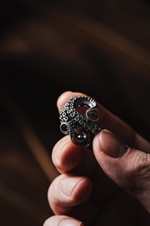 Hands holding a detailed 3D printed piece, highlighting the texture and precision