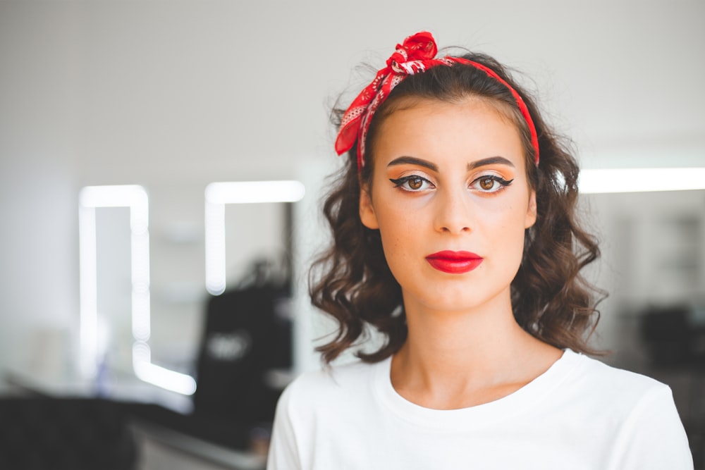 a woman with a red bow in her hair