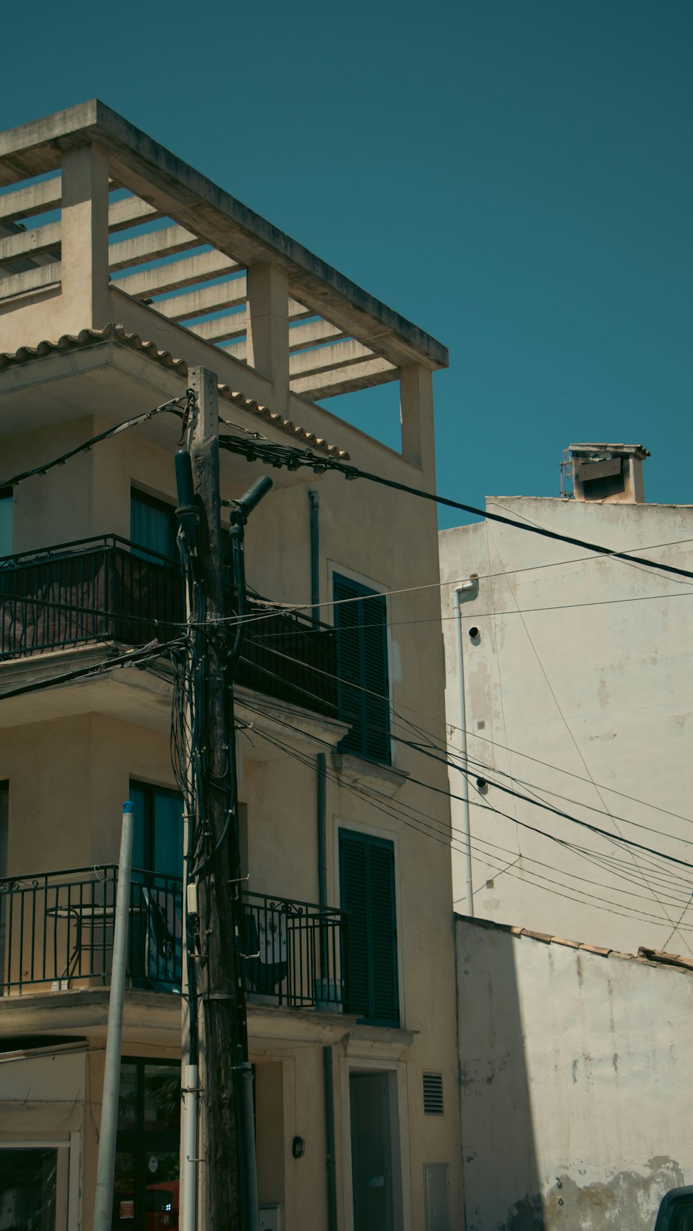 a tall building with a balcony next to a street