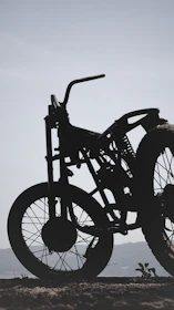 Side view of a minimalist sidecar on an urban street at sunset, emphasizing its sleek lines.