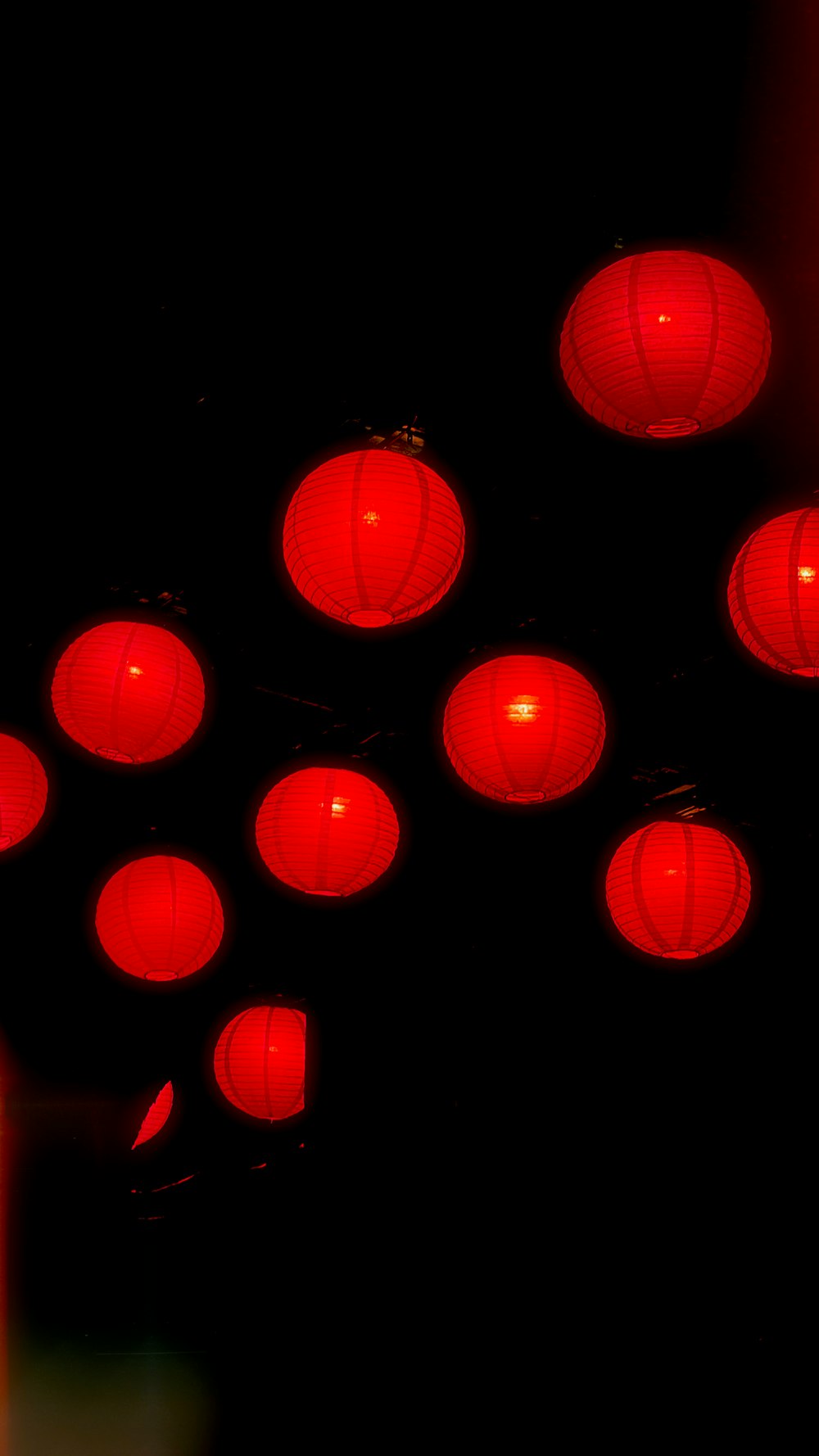 a group of red lanterns hanging from a ceiling