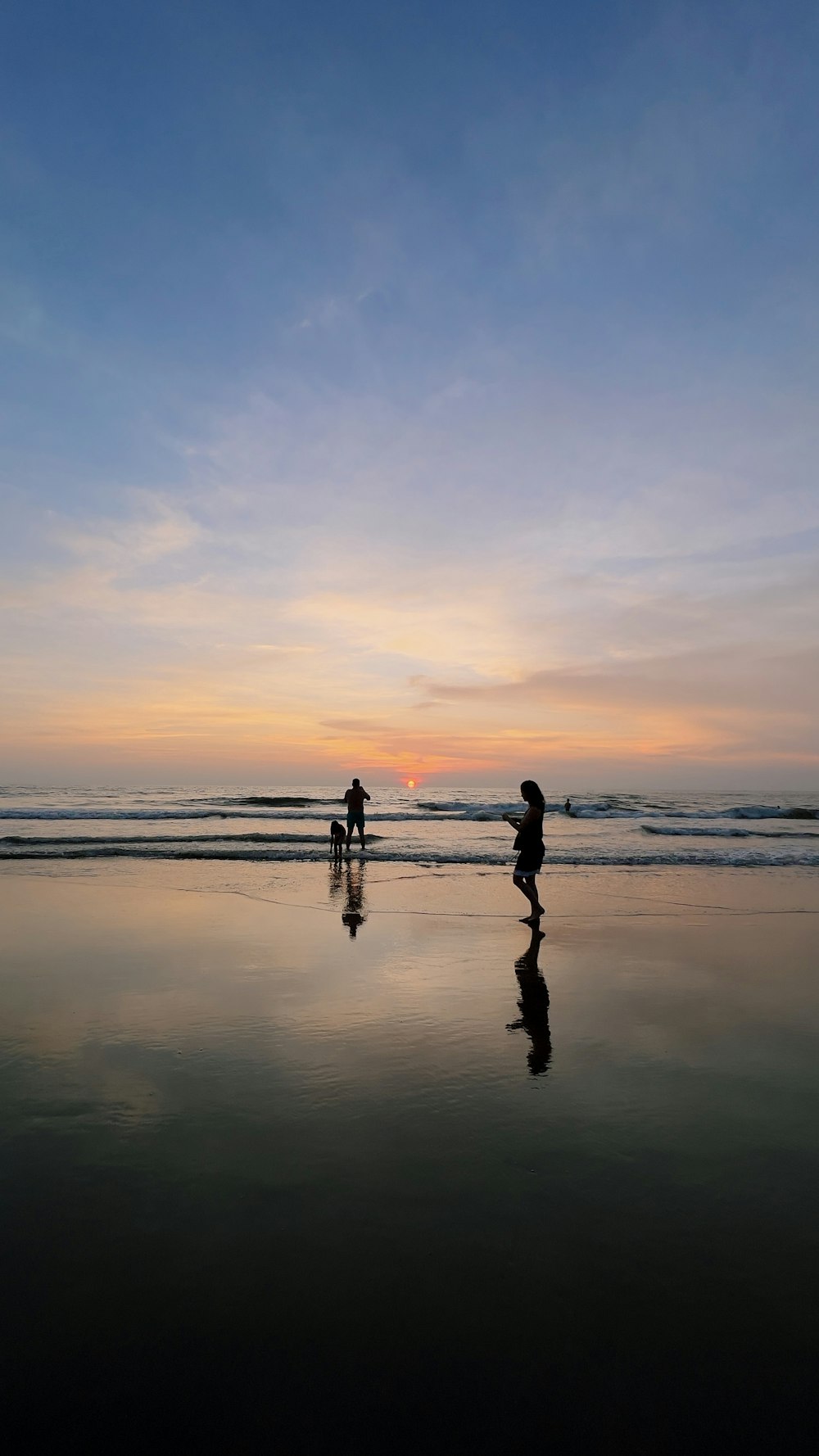 a couple of people that are standing in the sand