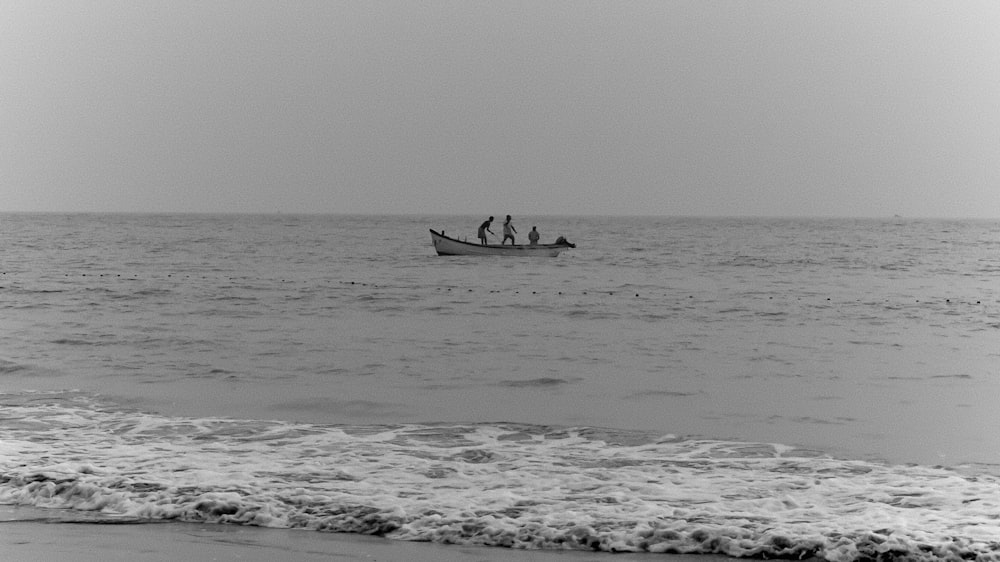 a black and white photo of a boat in the ocean