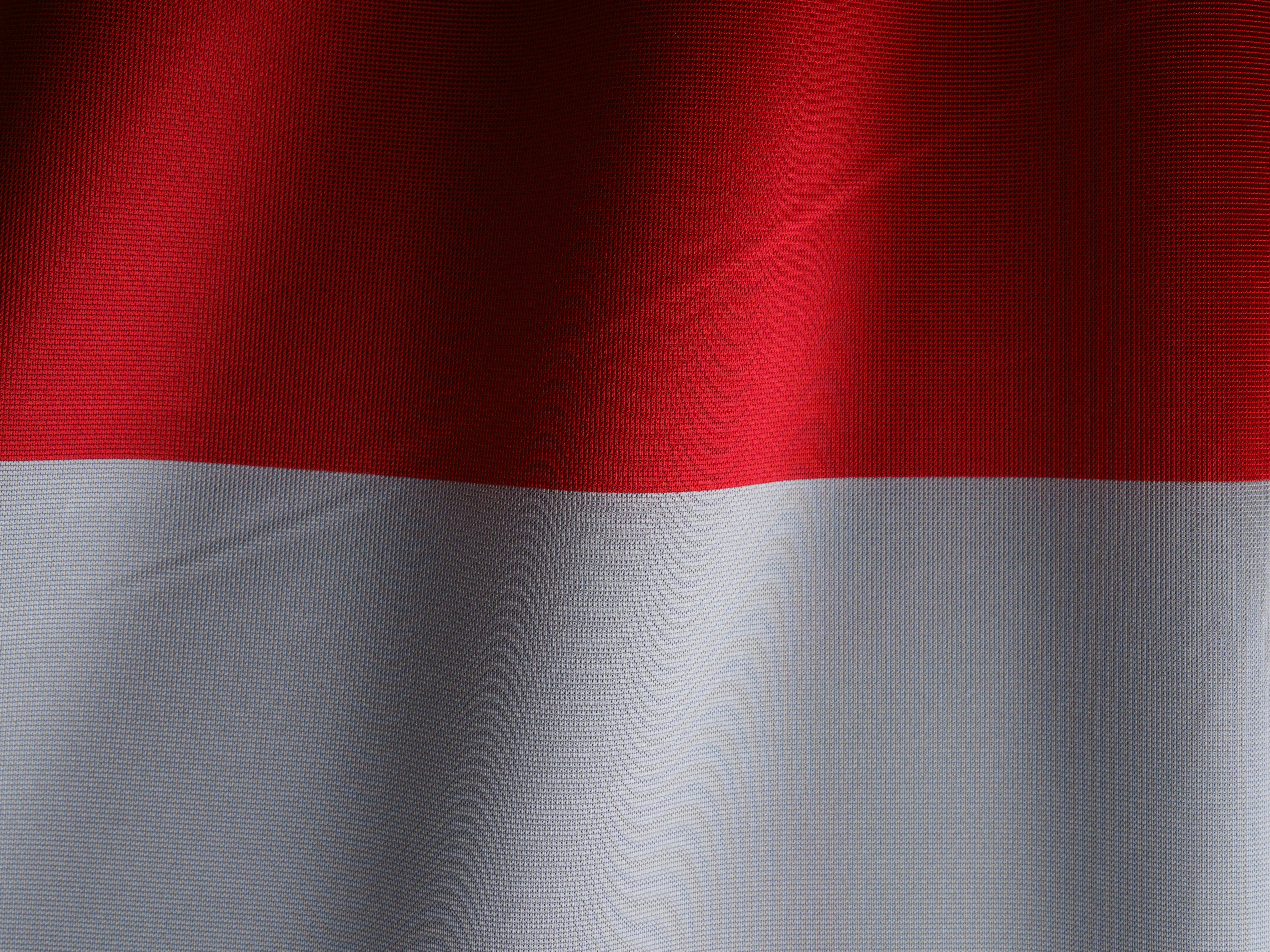 a close up of a red and white flag