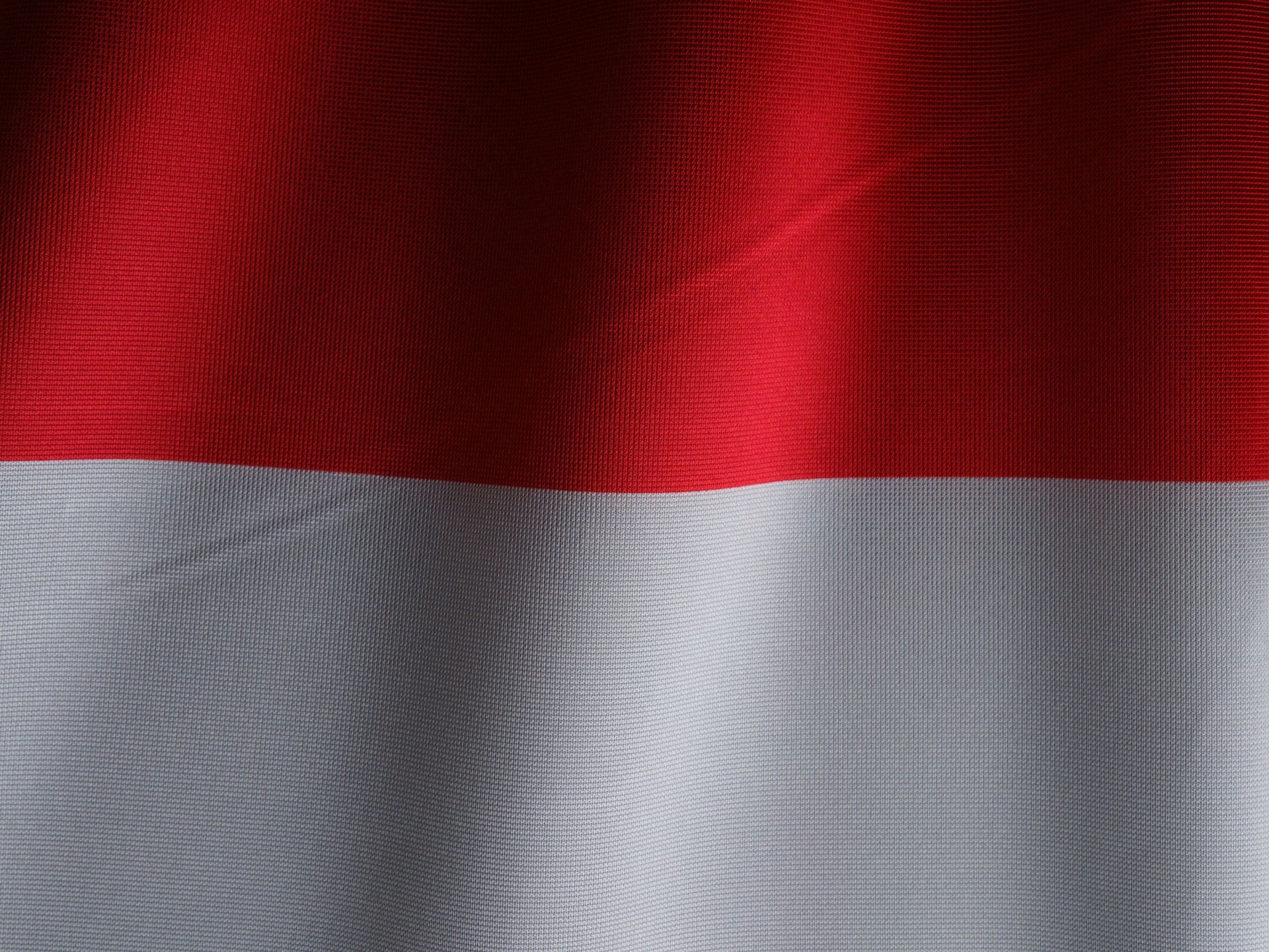 a close up of a red and white flag