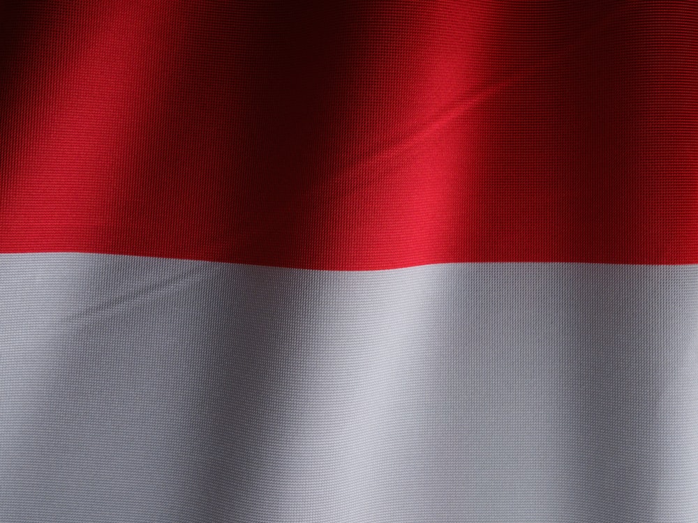 a close up of a red and white flag