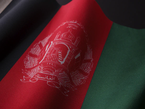 Red and black fabric door cover with embroidered symbols representing protection and axé.